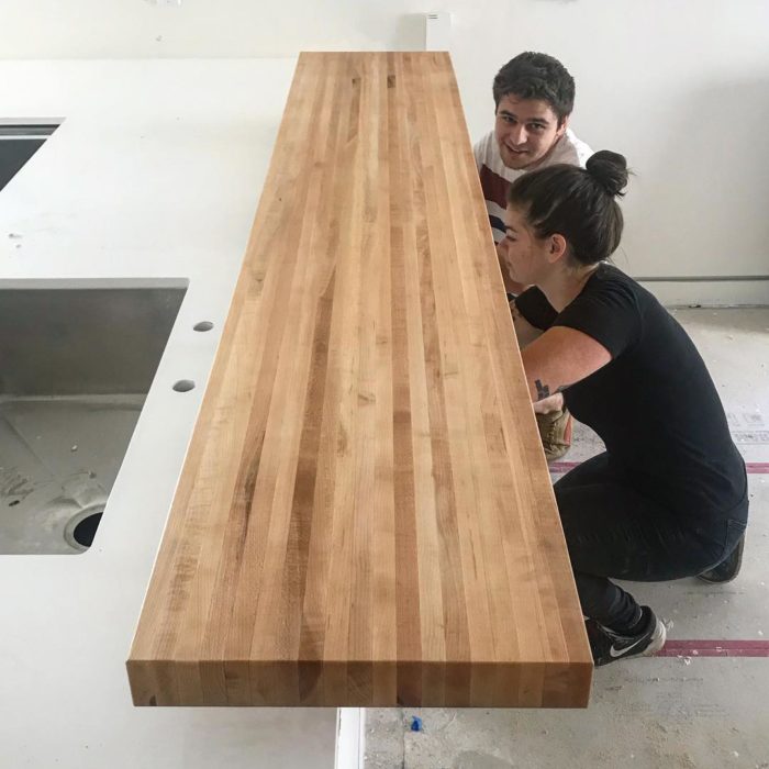 Telemachus Fabrication - Yes, we get our architects working in the field. Last of some bar top installation on three Small Lot projects for Oakmont Capital. We get involved when we can produce high-quality pieces cheaper than we can get through a subcontractor… like these 2/14” thick solid maple bar tops on stainless steel standoffs. We like every project to have detail that you can touch. Good clients make good projects